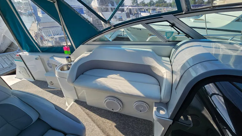 Slide: The Image of 1994 Formula 31 PC boat interior with white seating and teal canopy. - 8