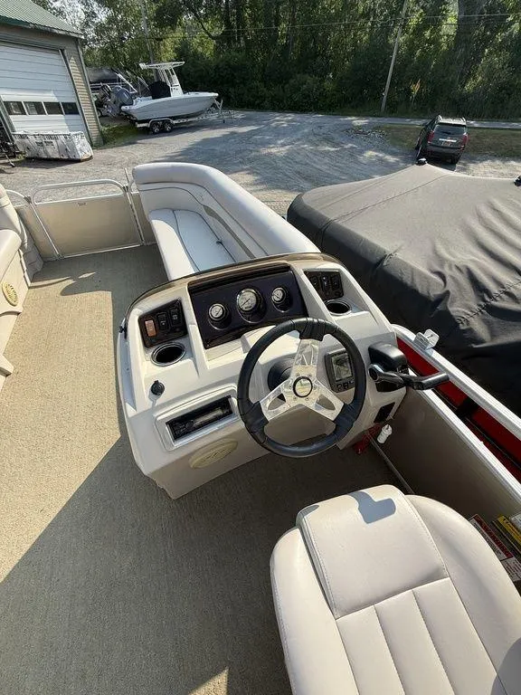 Slide: The Image of 2015 Bennington 21 SLX boat interior with steering wheel and seating area. - 25