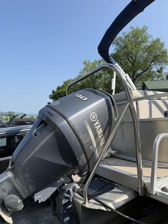 Slide: The Image of 2015 Bennington 21 SLX with Yamaha 90 outboard motor, parked outdoors. - 7