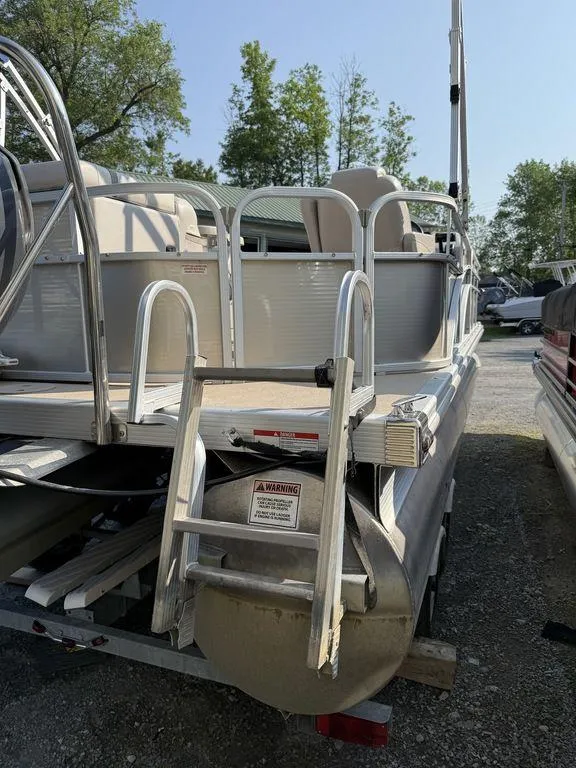 Slide: The Image of 2015 Bennington 21 SLX pontoon boat with ladder, parked on a trailer. - 9