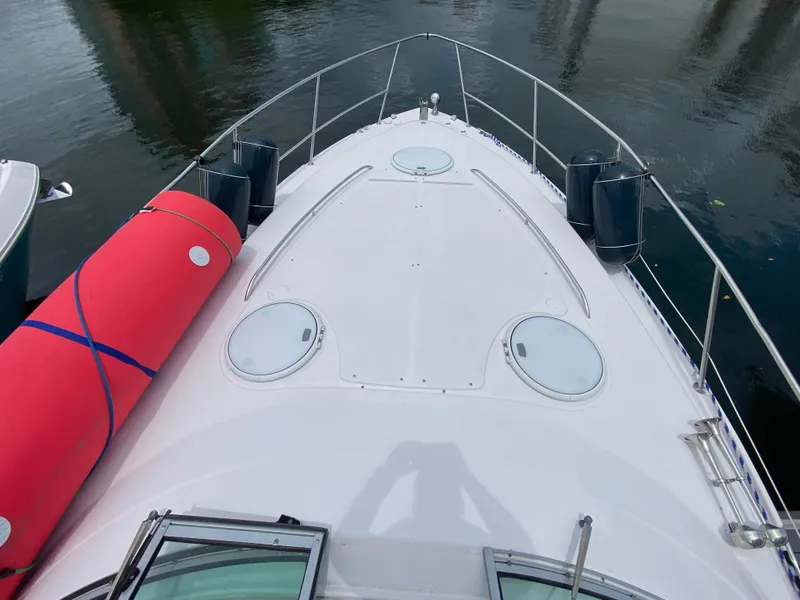 Slide: The Image of Bow view of 2006 Four Winns 348 Vista boat with red fender on deck. - 11