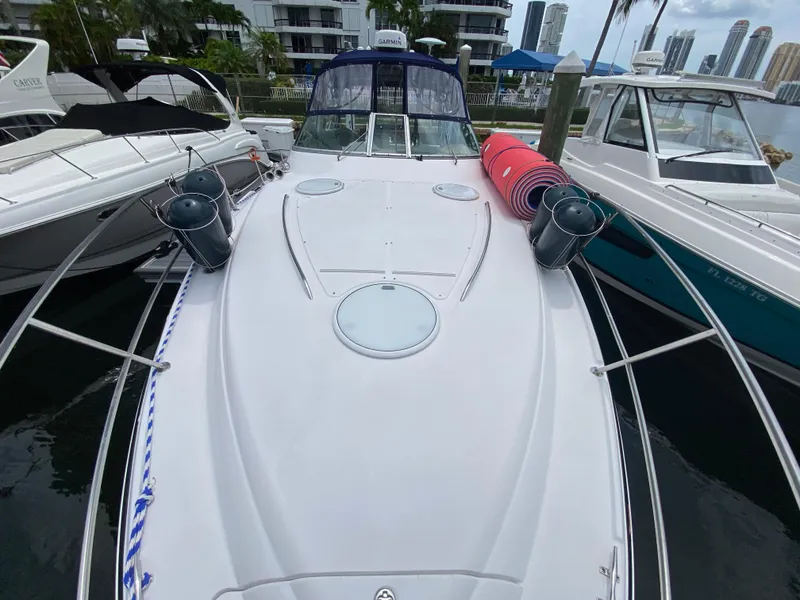 Slide: The Image of 2006 Four Winns 348 Vista boat docked, with fenders and rolled mats on deck. - 12