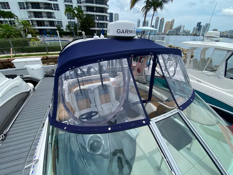 Slide: The Image of 2006 Four Winns 348 Vista boat docked with Garmin equipment, cityscape in background. - 14