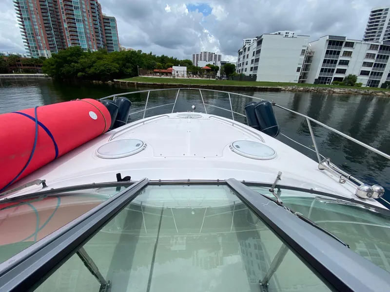 Slide: The Image of 2006 Four Winns 348 Vista yacht docked near modern waterfront buildings. - 15