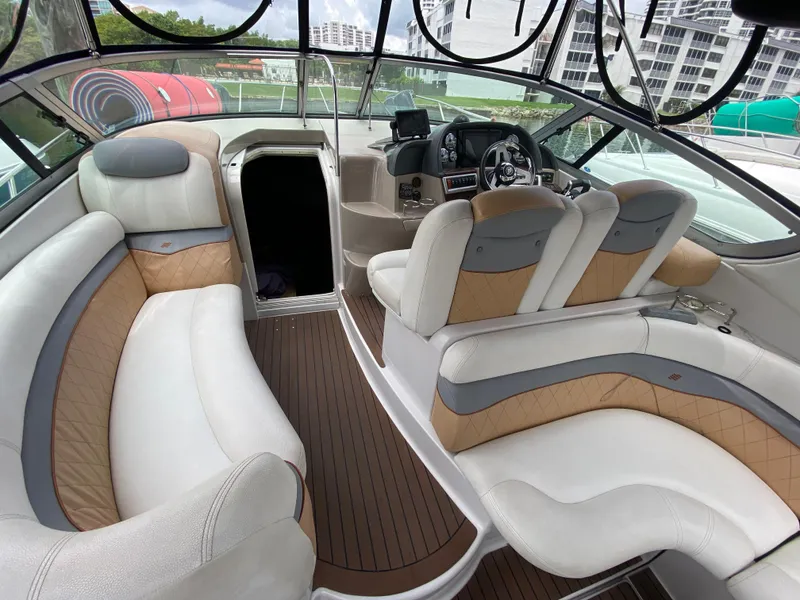 Slide: The Image of 2006 Four Winns 348 Vista boat interior with plush seating and modern dashboard. - 17