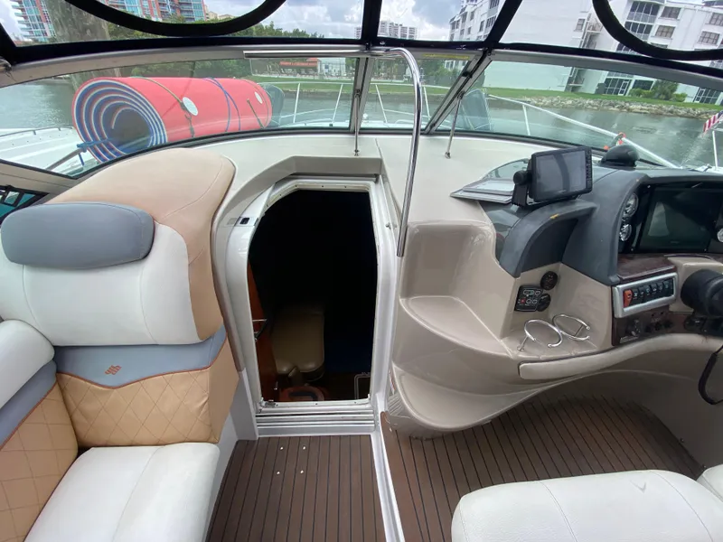 Slide: The Image of 2006 Four Winns 348 Vista boat interior with helm, seating, and cabin entrance. - 22