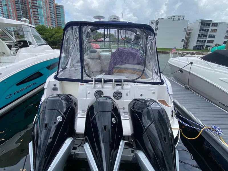Slide: The Image of 2006 Four Winns 348 Vista boat docked with triple outboard engines. - 26