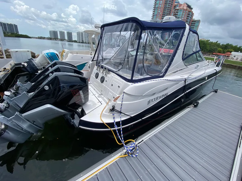 Slide: The Image of 2006 Four Winns 348 Vista boat docked with twin Mercury outboard engines. - 27