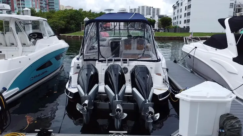 Slide: The Image of 2006 Four Winns 348 Vista boat docked with triple outboard engines. - 28