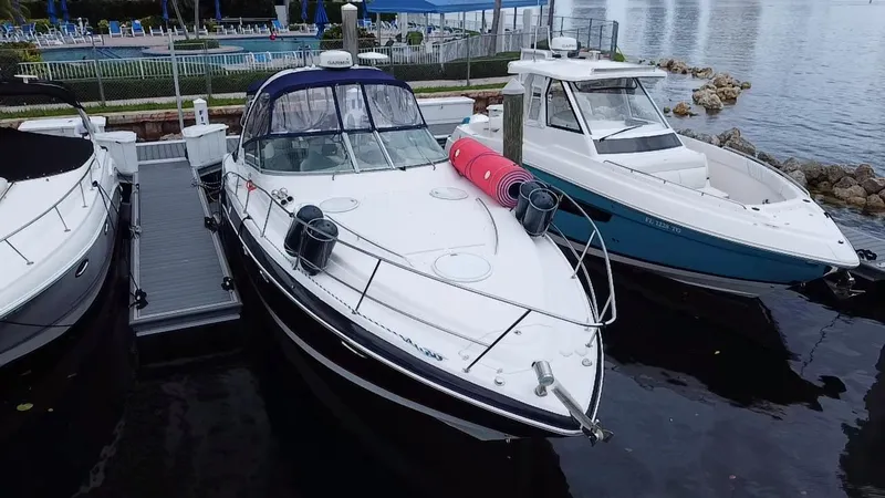 Slide: The Image of 2006 Four Winns 348 Vista boat docked beside other vessels at a marina. - 3