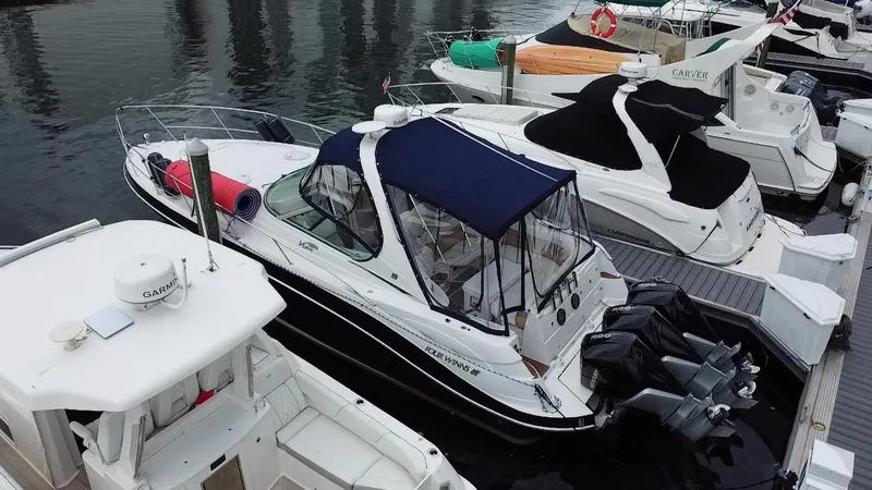 Slide: The Image of 2006 Four Winns 348 Vista boat docked at marina with other vessels. - 32