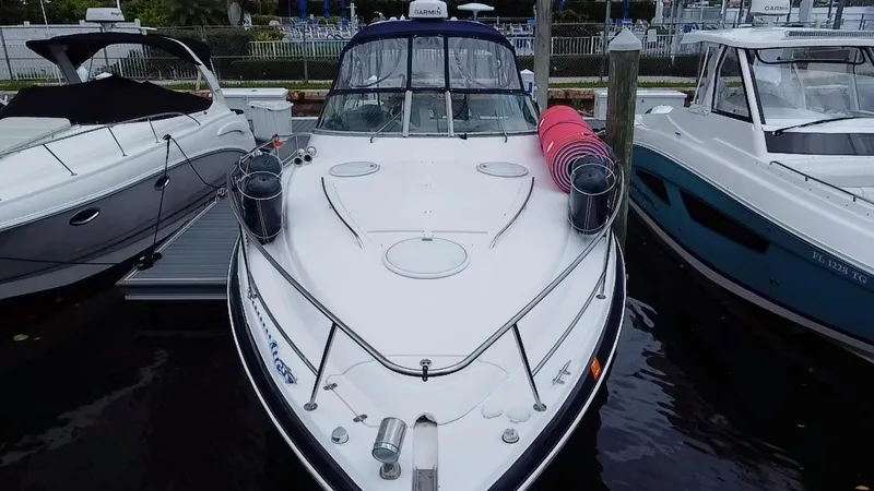 Slide: The Image of 2006 Four Winns 348 Vista boat docked between two other boats. - 4