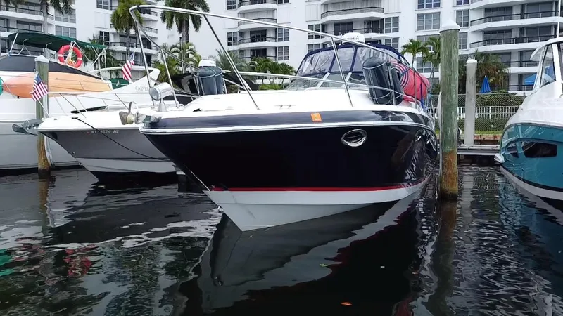 Slide: The Image of 2006 Four Winns 348 Vista boat docked in marina, surrounded by other vessels. - 6
