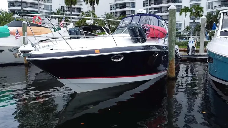 Slide: The Image of 2006 Four Winns 348 Vista boat docked in marina, surrounded by water and buildings. - 8