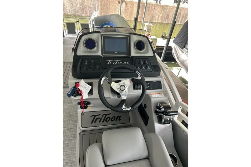 Slide: The Image of Cockpit of 2025 JC NEPTOON 27TT SPORT boat with steering wheel and controls. - 11