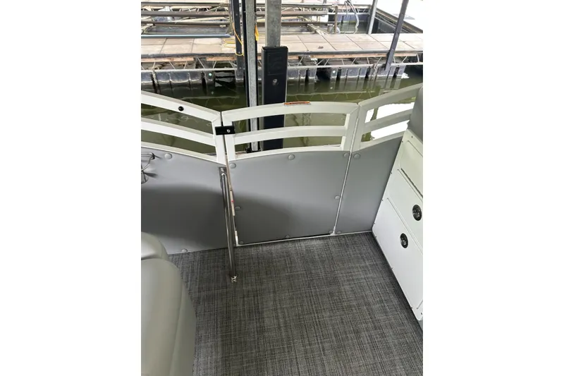 Slide: The Image of Interior view of 2025 JC NEPTOON 27TT SPORT boat with gray flooring and railing. - 18