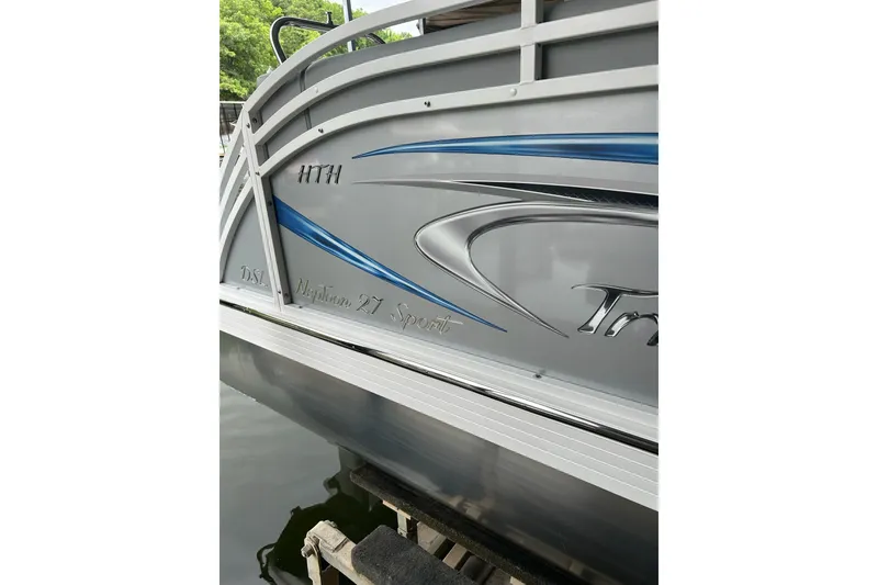 Slide: The Image of 2025 JC NEPTOON 27TT SPORT boat with sleek blue and silver design. - 24