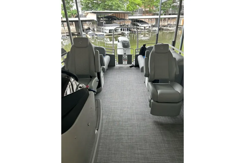 Slide: The Image of Interior of 2025 JC NEPTOON 27TT SPORT boat with gray seating and lake view. - 6