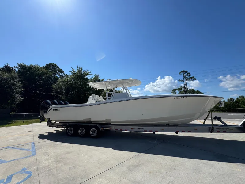 Slide: The Image of 2020 Invincible 39 Open Fisherman boat on trailer under clear blue sky. - 12