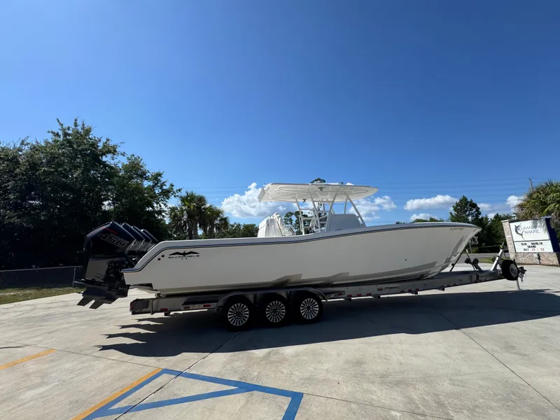 Slide: The Image of 2020 Invincible 39 Open Fisherman boat on trailer under clear blue sky. - 14