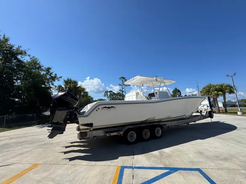 Slide: The Image of 2020 Invincible 39 Open Fisherman boat on trailer under clear blue sky. - 15