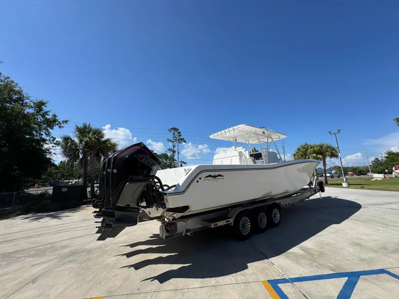 Slide: The Image of 2020 Invincible 39 Open Fisherman boat on trailer under clear blue sky. - 16