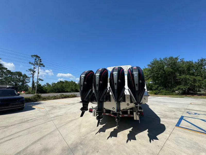Slide: The Image of 2020 Invincible 39 Open Fisherman with four powerful outboard motors in a sunny outdoor setting. - 19