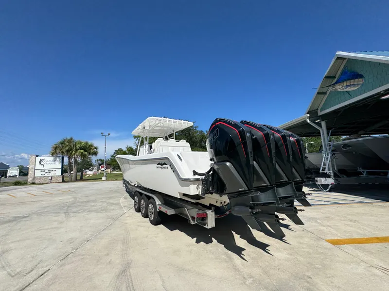 Slide: The Image of 2020 Invincible 39 Open Fisherman boat with four powerful outboard engines in a marina. - 22