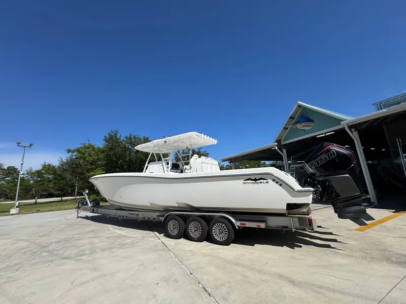 Slide: The Image of 2020 Invincible 39 Open Fisherman boat on trailer under clear blue sky. - 24