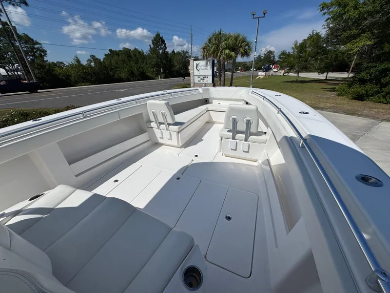 Slide: The Image of 2020 Invincible 39 Open Fisherman boat interior with seating, docked outdoors. - 25