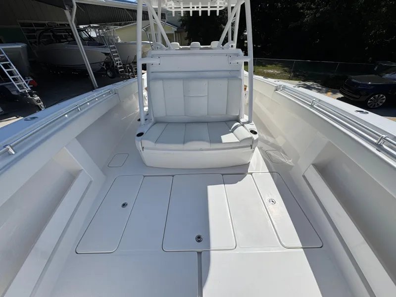 Slide: The Image of 2020 Invincible 39 Open Fisherman boat interior with white seating and storage compartments. - 31