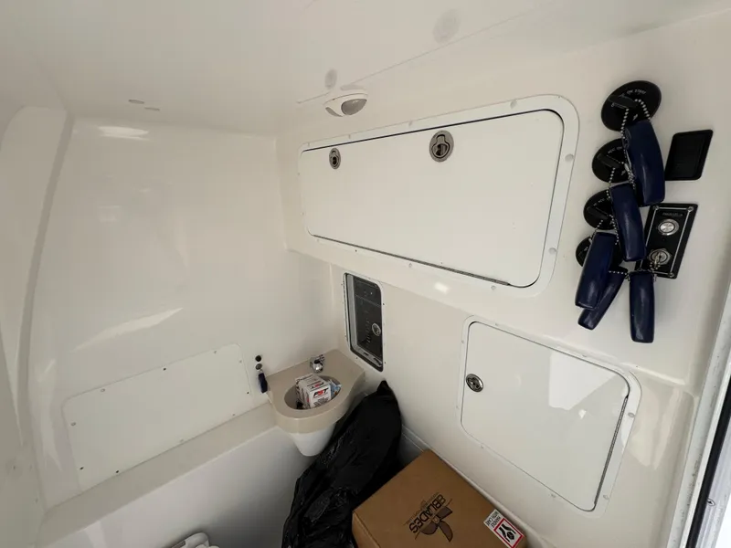 Slide: The Image of Interior of 2020 Invincible 39 Open Fisherman boat with storage compartments and controls. - 35