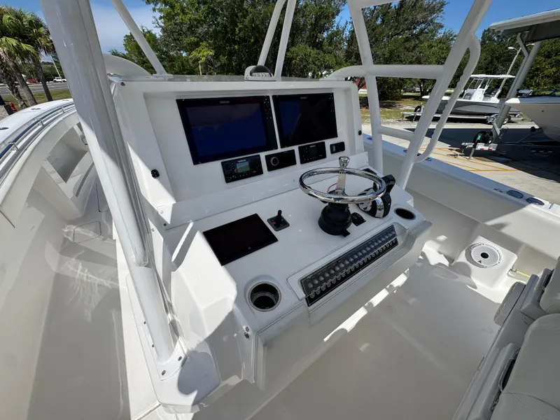 Slide: The Image of 2020 Invincible 39 Open Fisherman boat helm with dual screens and steering wheel. - 38