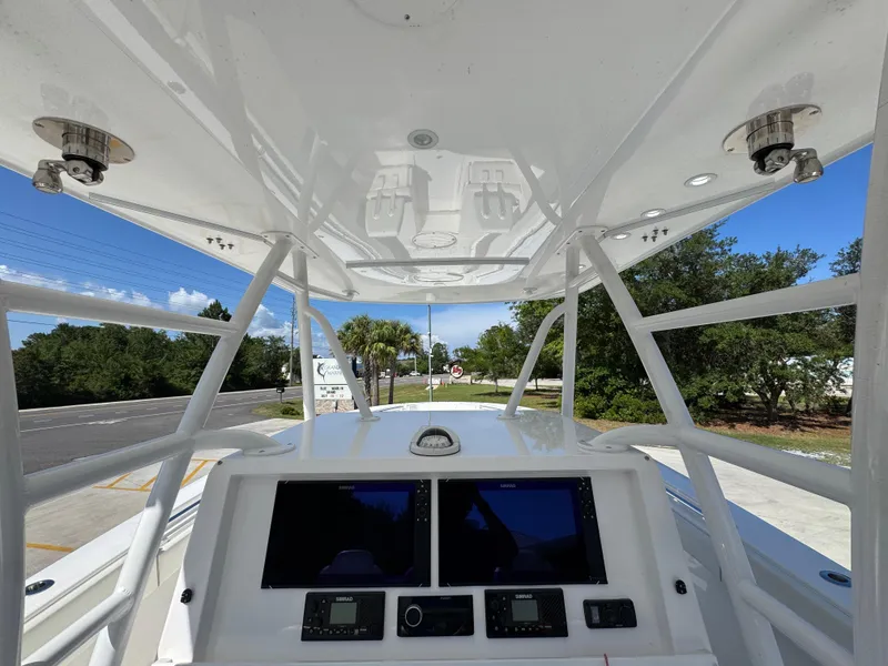Slide: The Image of 2020 Invincible 39 Open Fisherman boat console with dual screens and overhead view. - 40