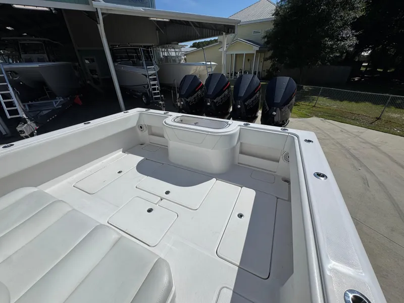 Slide: The Image of 2020 Invincible 39 Open Fisherman boat with multiple outboard engines in a marina. - 43