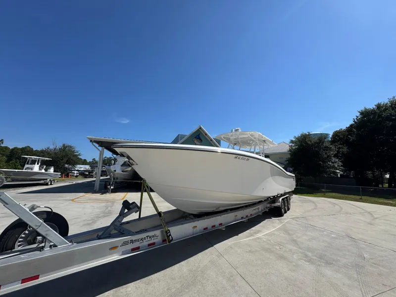 Slide: The Image of 2020 Invincible 39 Open Fisherman boat on trailer under clear blue sky. - 5