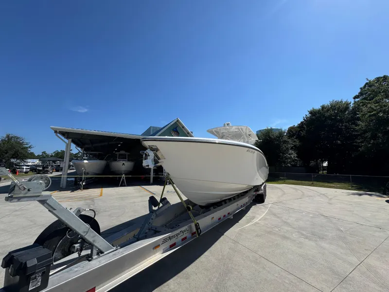 Slide: The Image of 2020 Invincible 39 Open Fisherman boat on trailer under clear blue sky. - 6