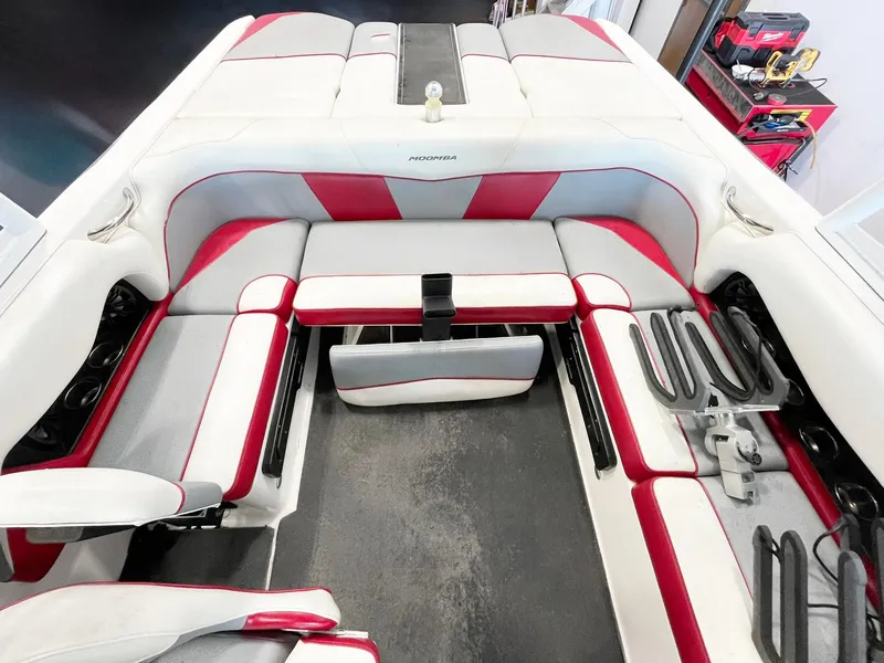 Slide: The Image of 2016 Moomba Mondo boat interior with red and white seating and storage compartments. - 7