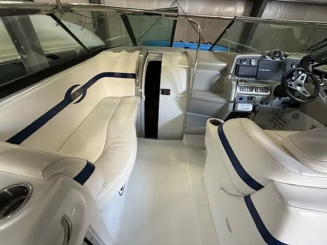 Slide: The Image of 2012 Formula 350 Sun Sport boat interior with white seating and modern dashboard. - 12