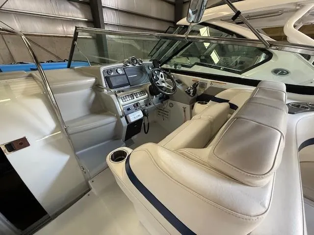 Slide: The Image of 2012 Formula 350 Sun Sport boat interior with helm, steering wheel, and seating. - 13