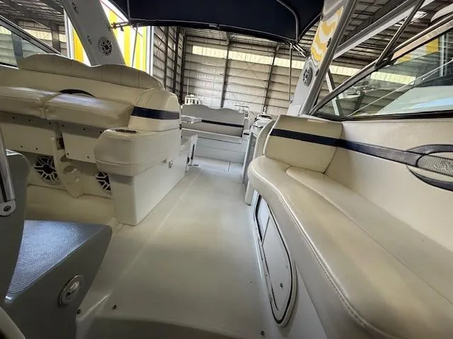 Slide: The Image of 2012 Formula 350 Sun Sport boat interior with white seating and storage compartments. - 14