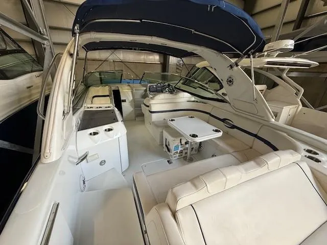 Slide: The Image of 2012 Formula 350 Sun Sport boat interior with seating and table, under a blue canopy. - 15