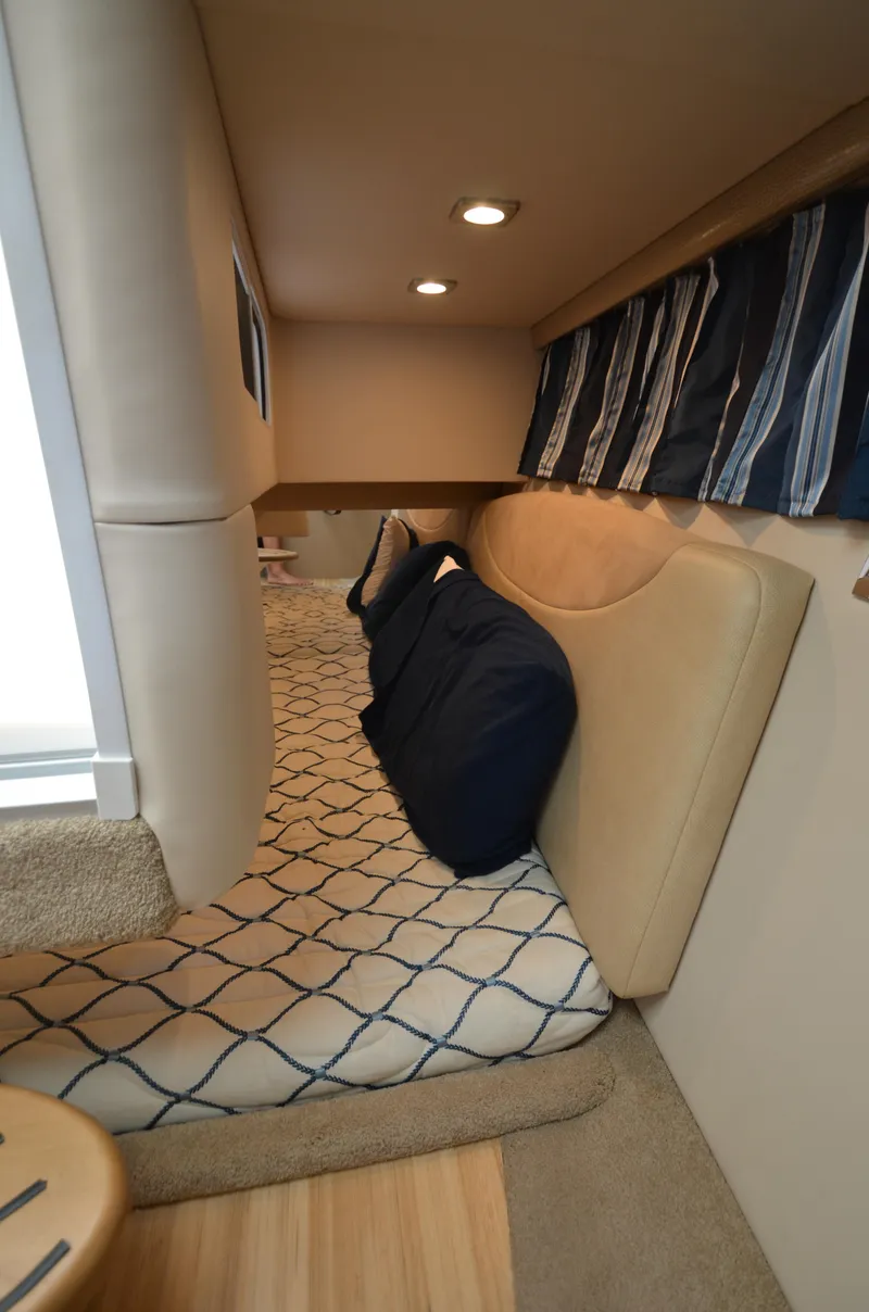 Slide: The Image of Interior cabin of 2012 Formula 350 Sun Sport with cozy seating and nautical decor. - 16