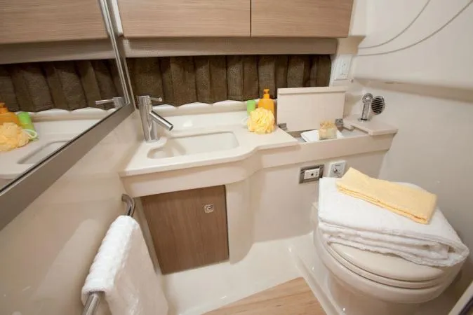 Slide: The Image of Manufacturer Provided Image: 2012 Formula 350 Sun Sport bathroom with sink, mirror, and toilet. - 17
