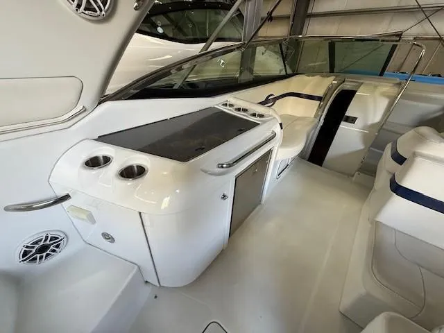 Slide: The Image of 2012 Formula 350 Sun Sport boat interior with seating and kitchenette. - 21