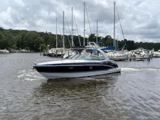 Slide: The Image of 2012 Formula 350 Sun Sport boat cruising in a marina with sailboats in the background. - 3