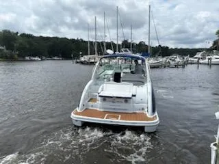 Slide: The Image of 2012 Formula 350 Sun Sport boat cruising on a lake with marina in background. - 34