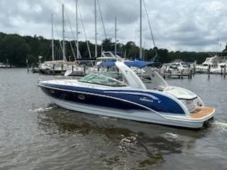 Slide: The Image of 2012 Formula 350 Sun Sport boat on a calm marina with sailboats. - 37