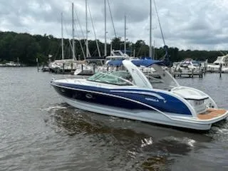 Slide: The Image of 2012 Formula 350 Sun Sport boat cruising on a lake with sailboats in the background. - 4