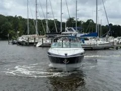 Slide: The Image of 2012 Formula 350 Sun Sport boat navigating marina with sailboats in background. - 40
